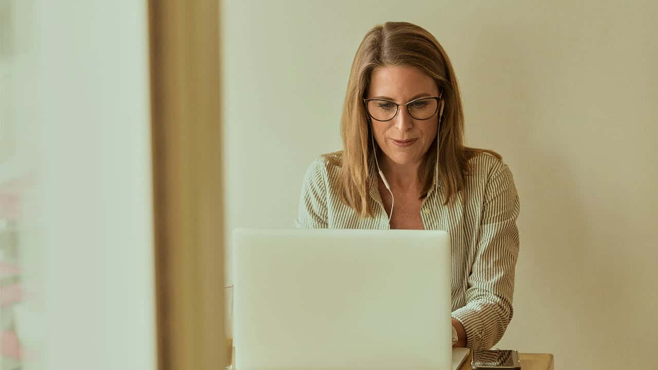 Person working on a laptop in a minimalist environment